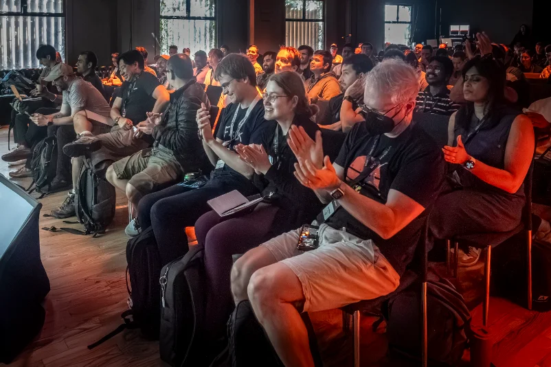 Audience applauding a session at DPE Summit 2025
